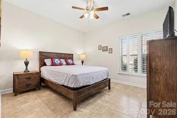 a spacious bedroom with a bed and a window