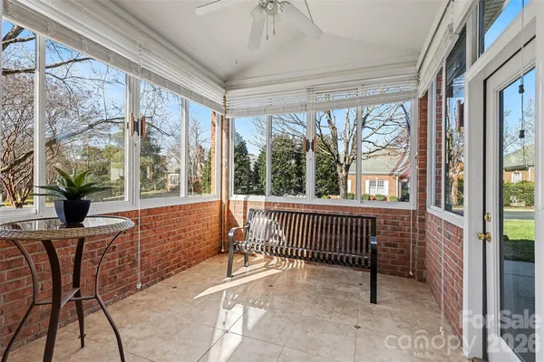 a view of a porch with a table and chairs