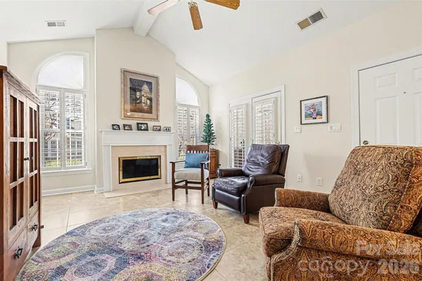 a living room with furniture a rug and a fireplace
