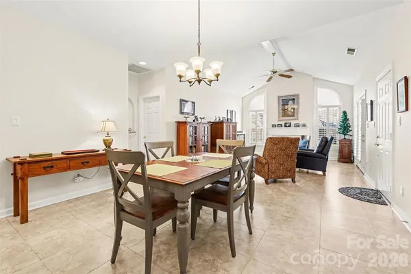 a view of a dining room with furniture and a chandelier