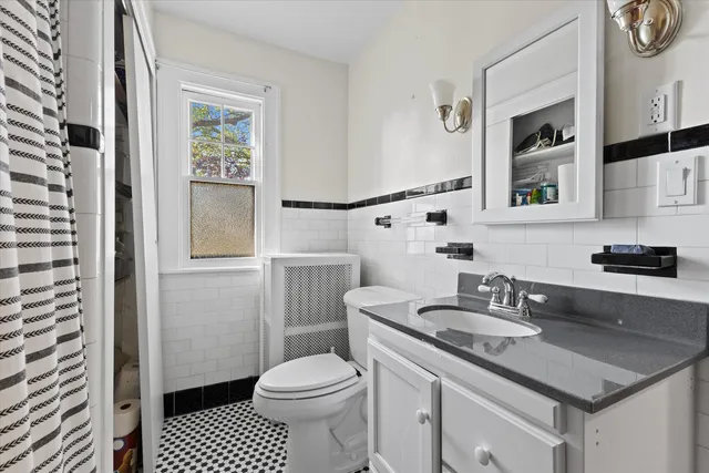 a bathroom with a sink a toilet and a mirror