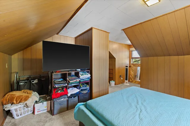 a bed room with a bed and a flat screen tv