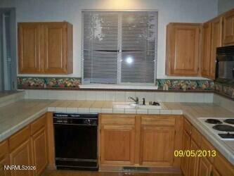 2249 Evans Creek Terrace Reno, NV 89519 - Photo 14 of 16 a kitchen with a stove and a sink