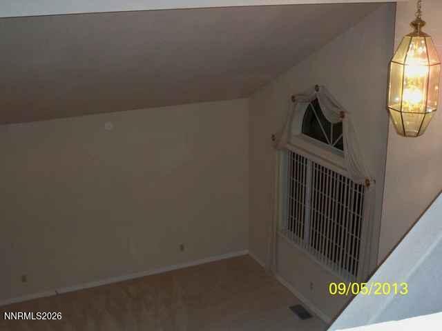 2249 Evans Creek Terrace Reno, NV 89519 - Photo 10 of 16 a view of stairs and utility room with wooden floor