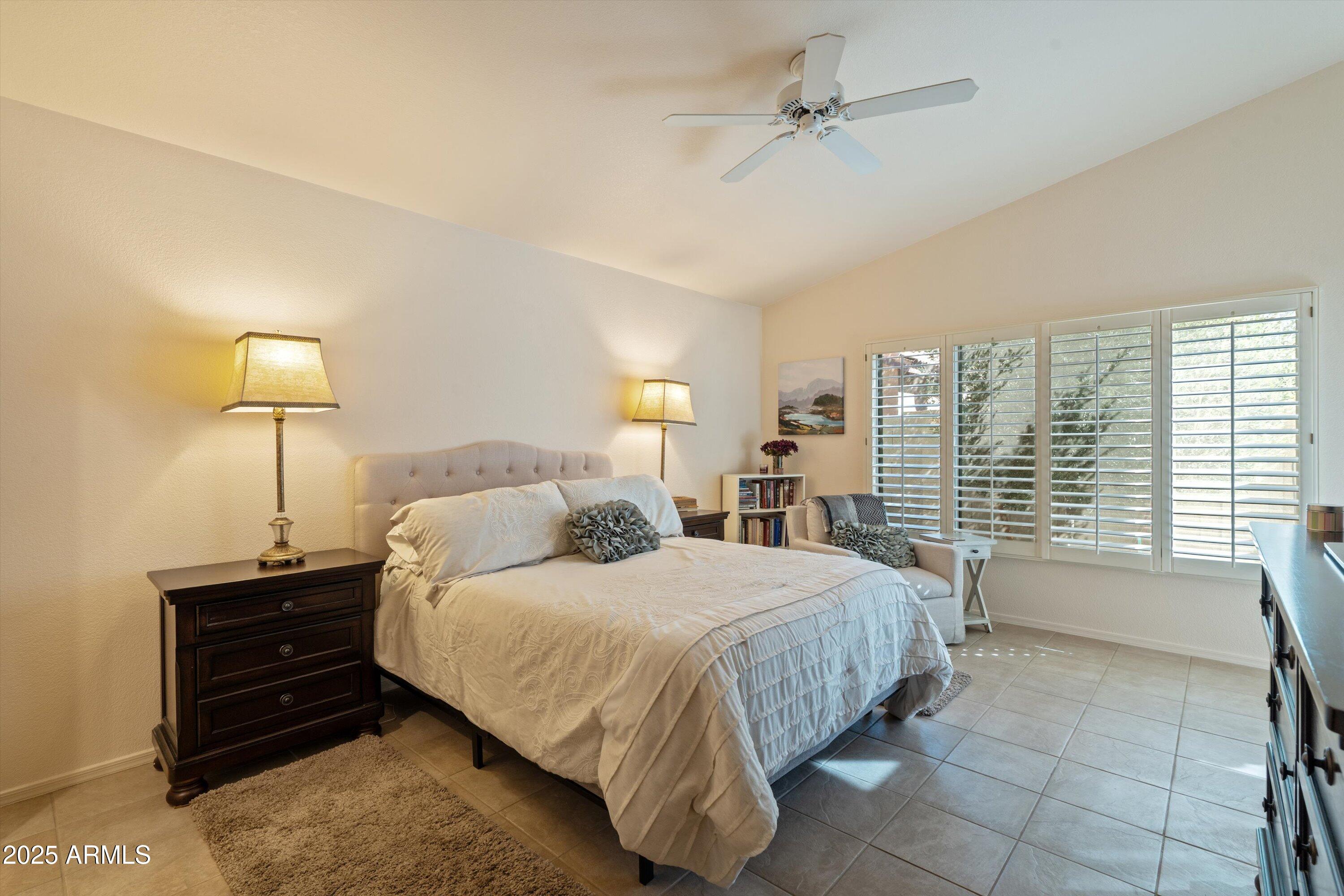 15415 West Merrell Street Goodyear, AZ 85395 - Photo 12 of 33 a bedroom with a bed and ceiling fan