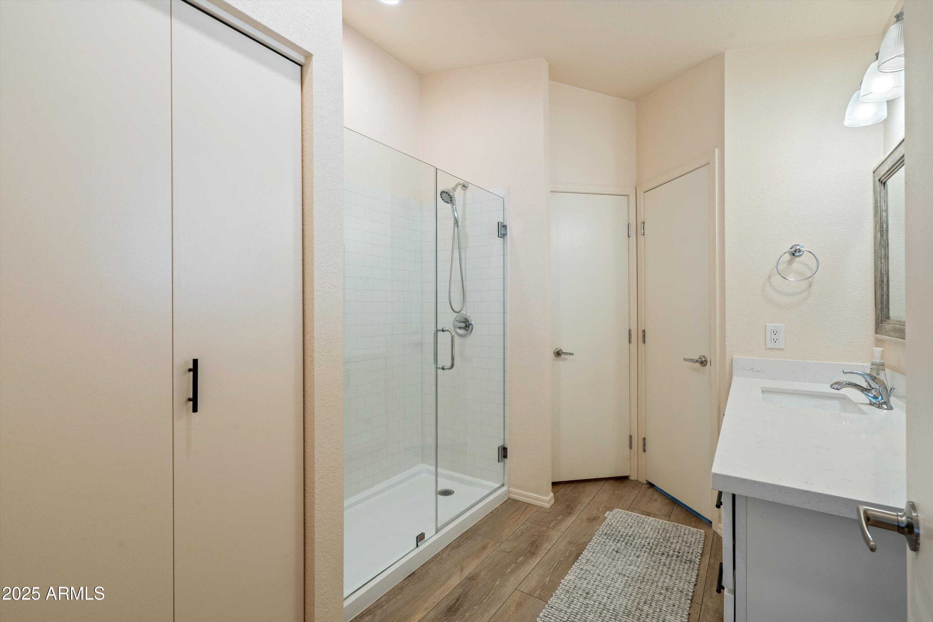 15415 West Merrell Street Goodyear, AZ 85395 - Photo 15 of 33 a bathroom with a shower and a glass door