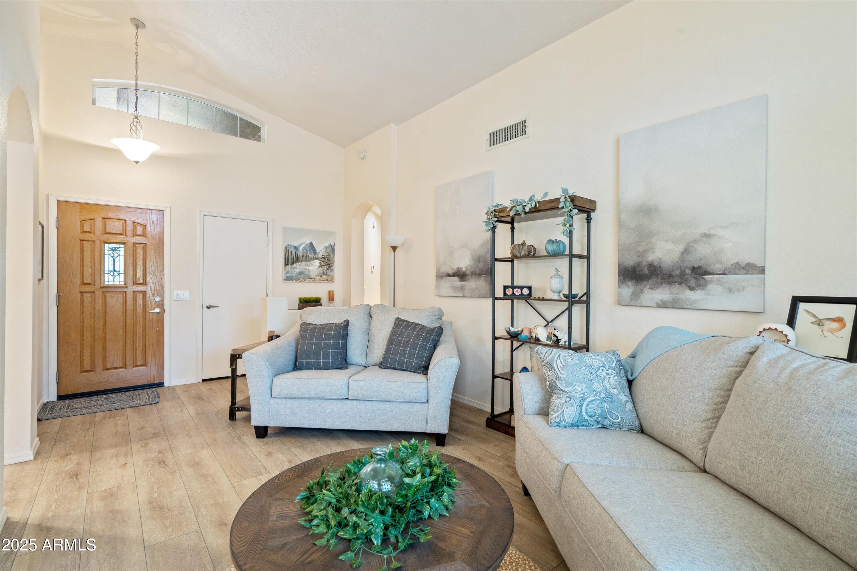 15415 West Merrell Street Goodyear, AZ 85395 - Photo 2 of 33 a living room with furniture and wooden floor