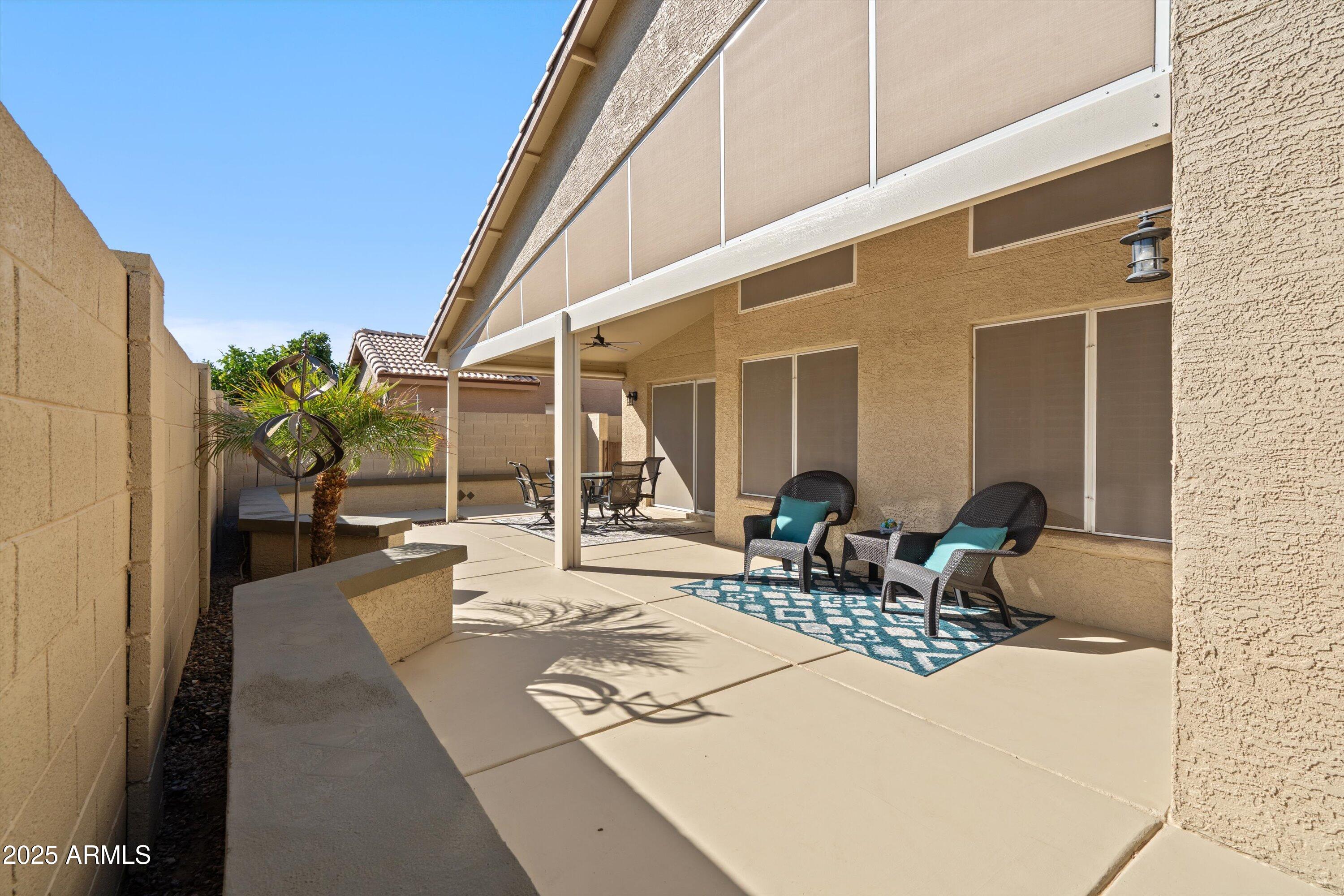 15415 West Merrell Street Goodyear, AZ 85395 - Photo 25 of 33 a view of a patio with table and chairs and potted plants