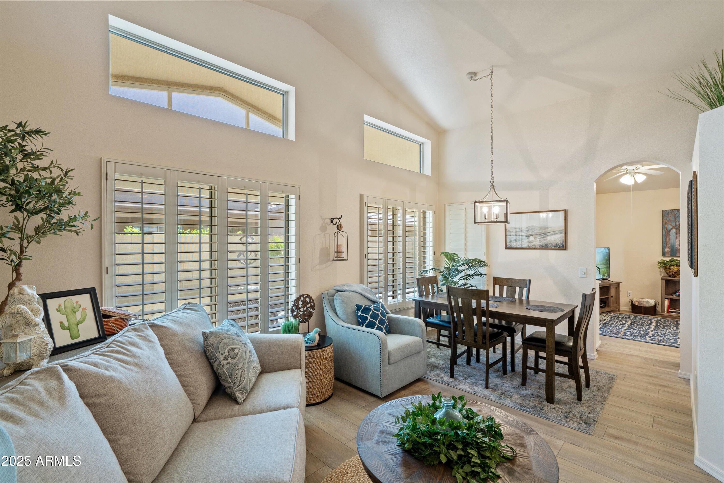 15415 West Merrell Street Goodyear, AZ 85395 - Photo 3 of 33 a living room with furniture and wooden floor