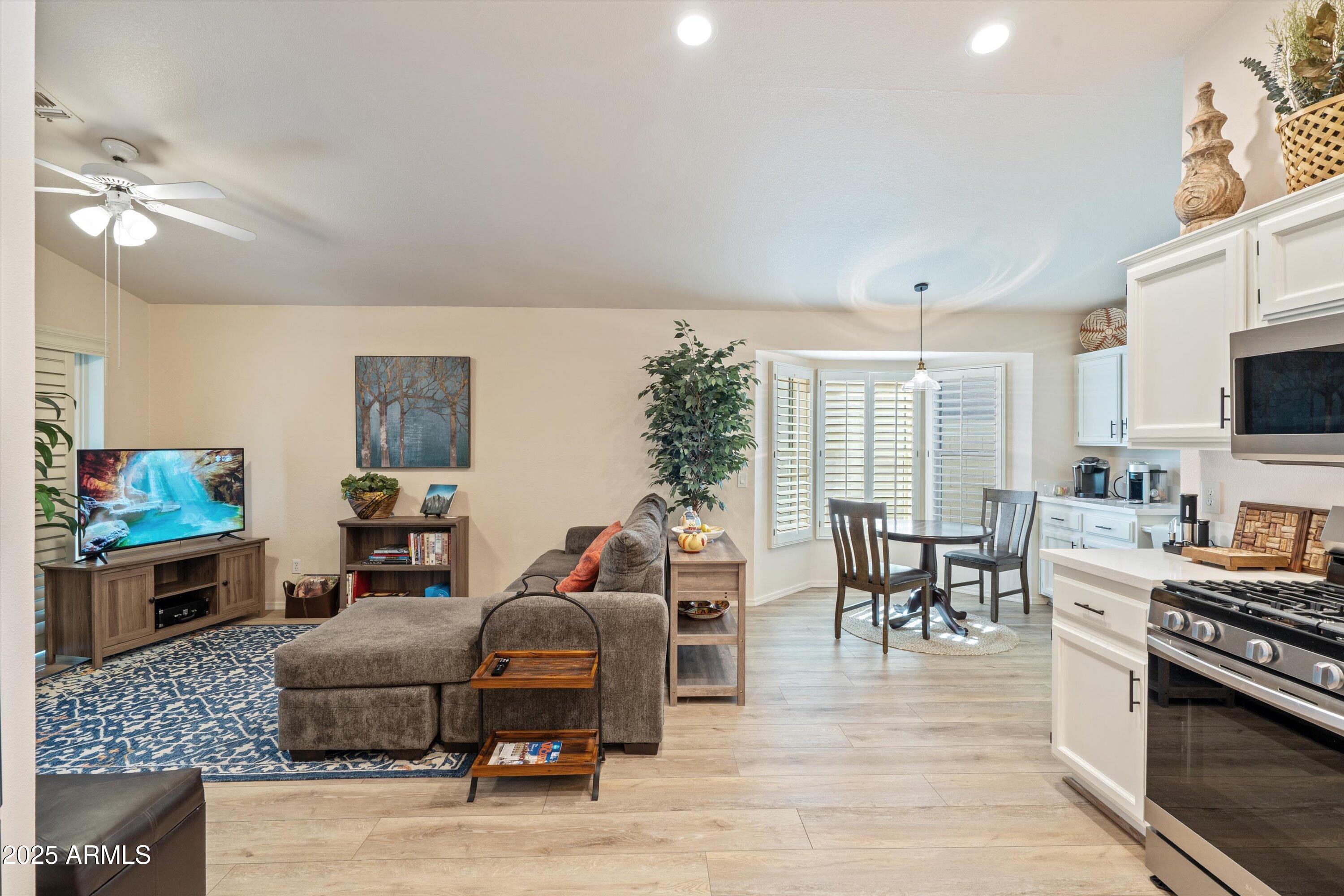 15415 West Merrell Street Goodyear, AZ 85395 - Photo 10 of 33 a living room with furniture flat screen tv and kitchen view