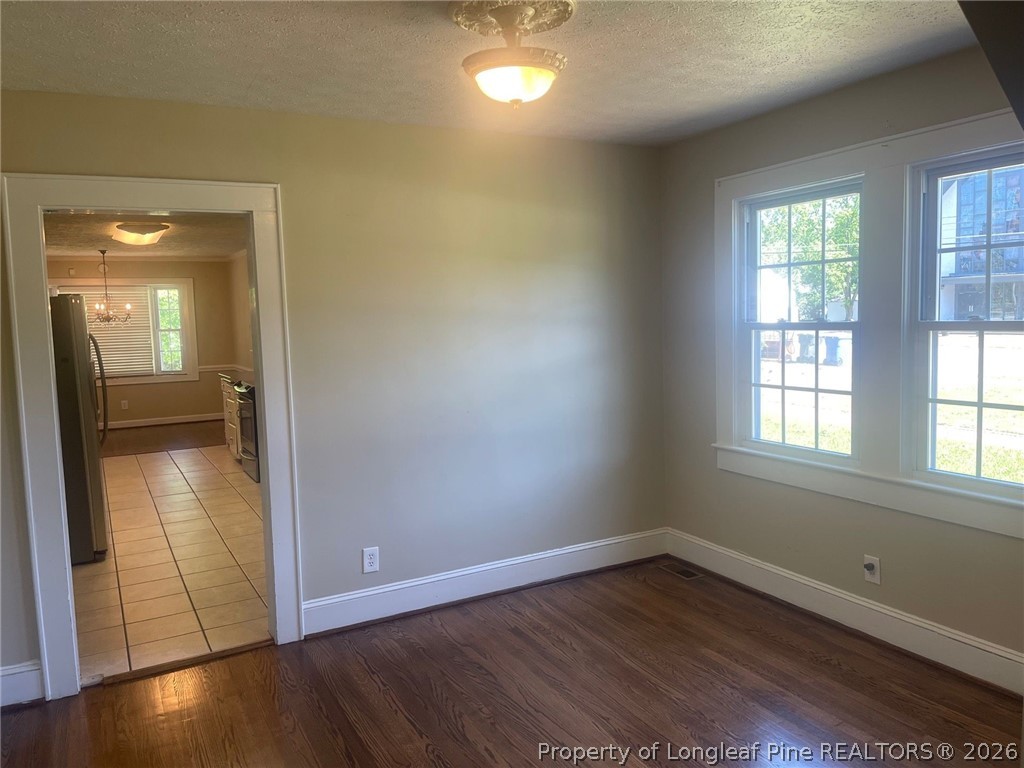 2515 Fort Bragg Road Fayetteville, NC 28303 - Photo 13 of 23 an empty room with wooden floor and windows