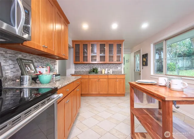 a kitchen with stainless steel appliances granite countertop a sink and cabinets
