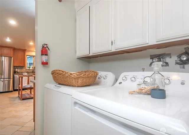 a kitchen with a refrigerator and cabinets