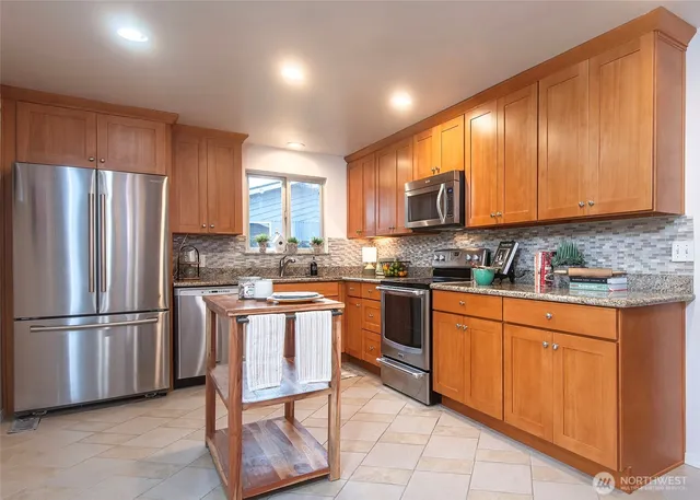 a kitchen with stainless steel appliances granite countertop a refrigerator sink and cabinets