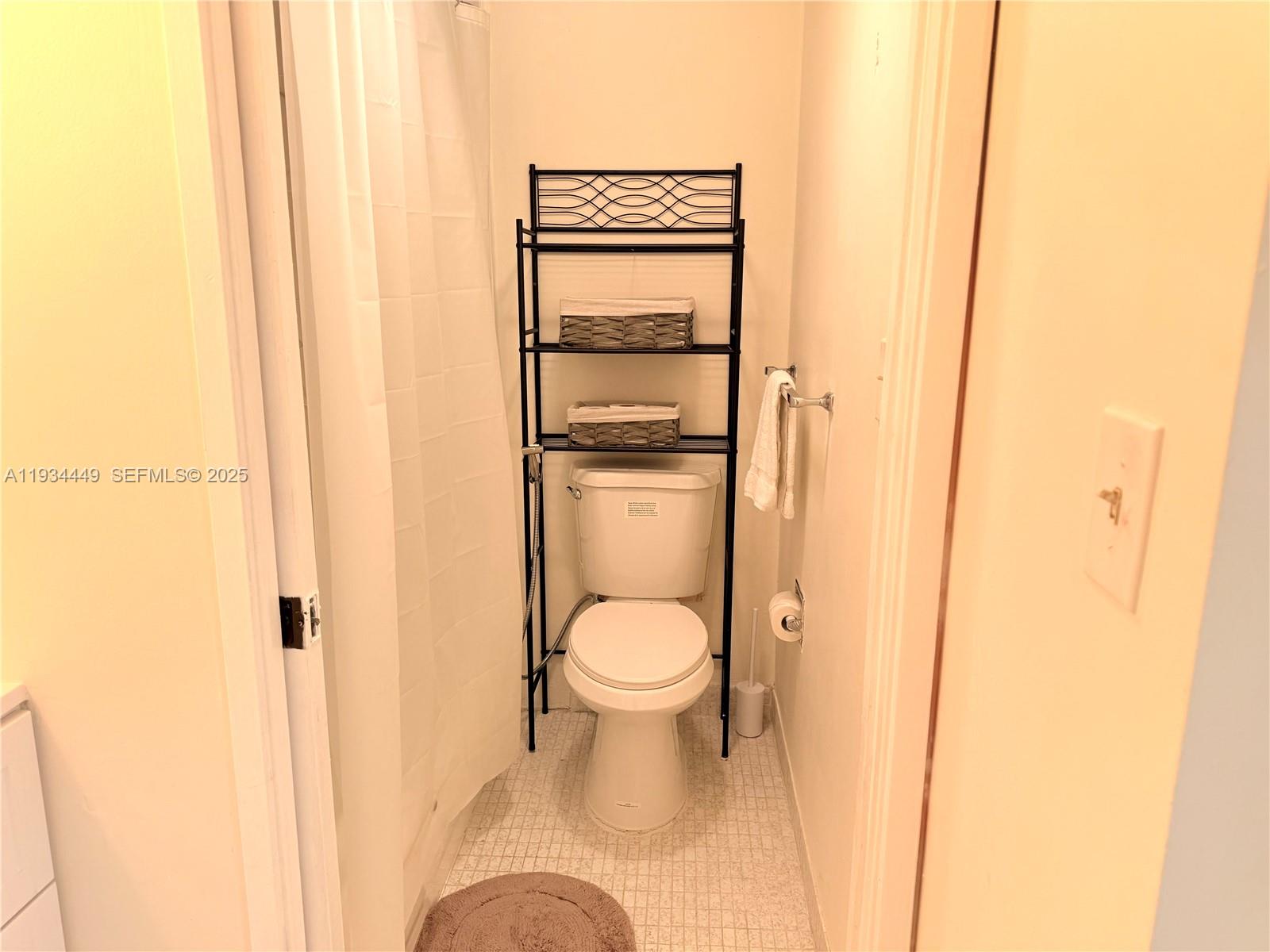 16909 North Bay Road, Unit 519 Sunny Isles Beach, FL 33160 - Photo 8 of 11 a white toilet sitting next to a shower