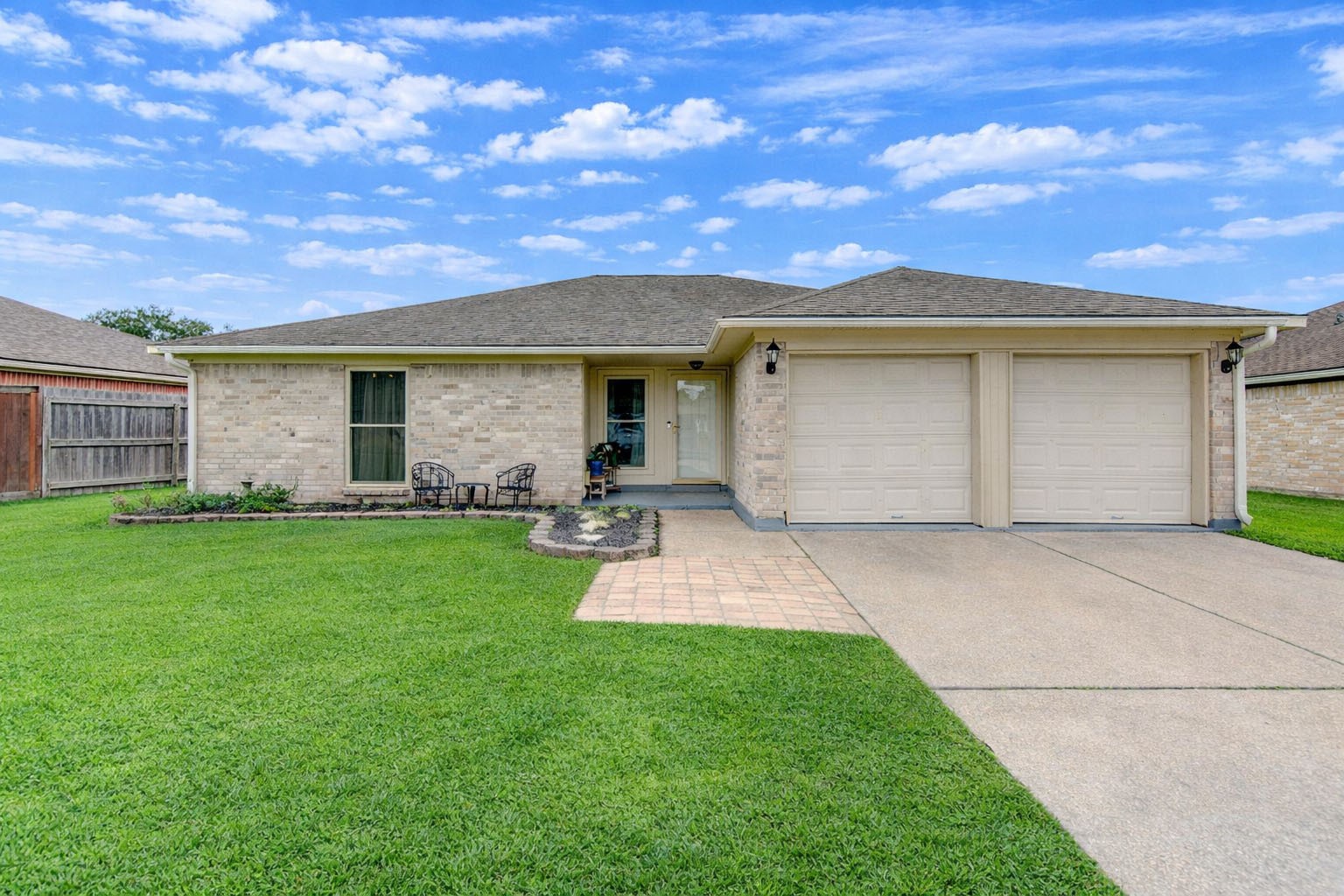 a front view of house with yard and outdoor seating