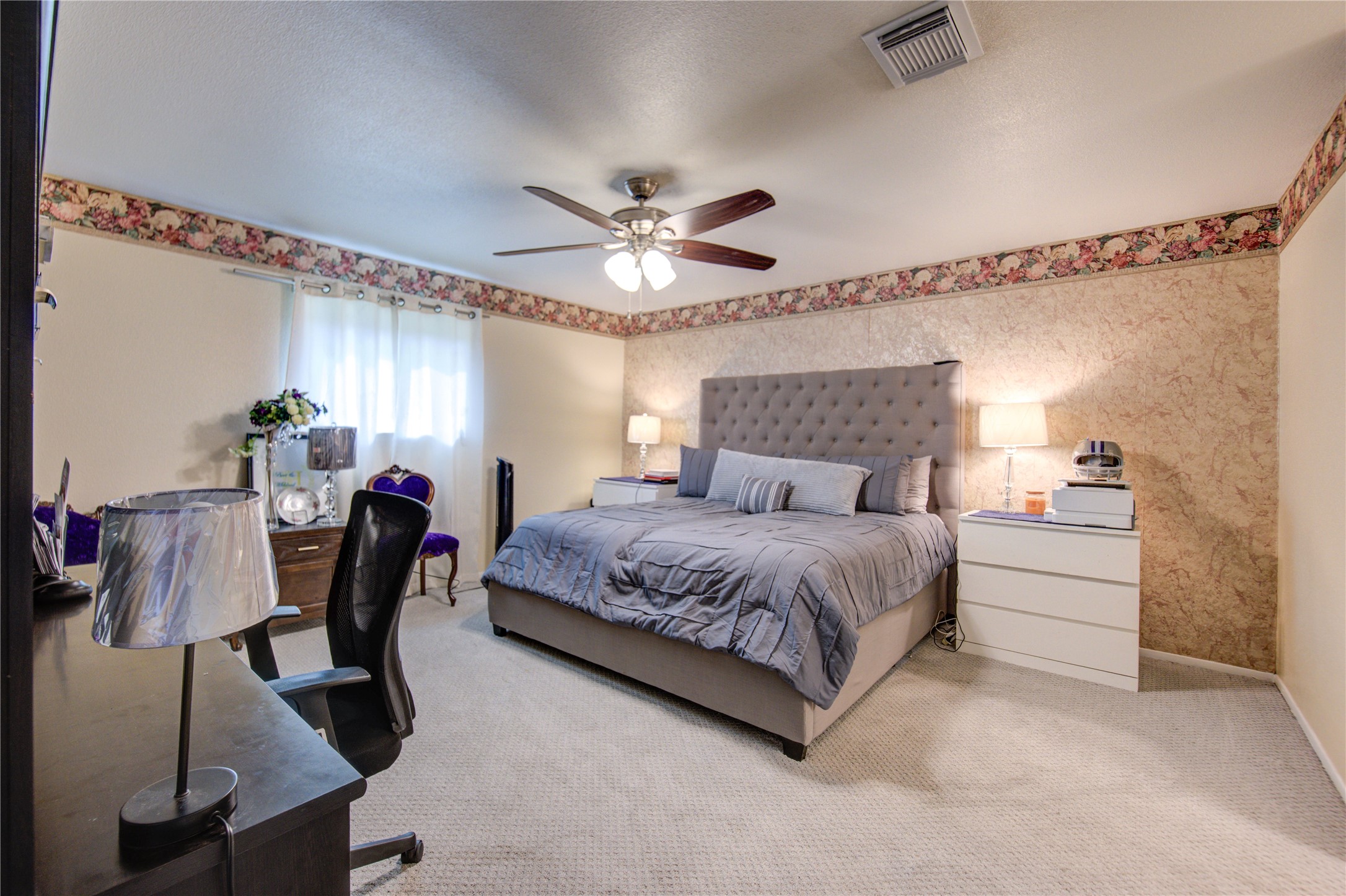 1403 Packsaddle Lane Baytown, TX 77521 - Photo 14 of 19 a bedroom with a bed a chair and potted plant on the dresser