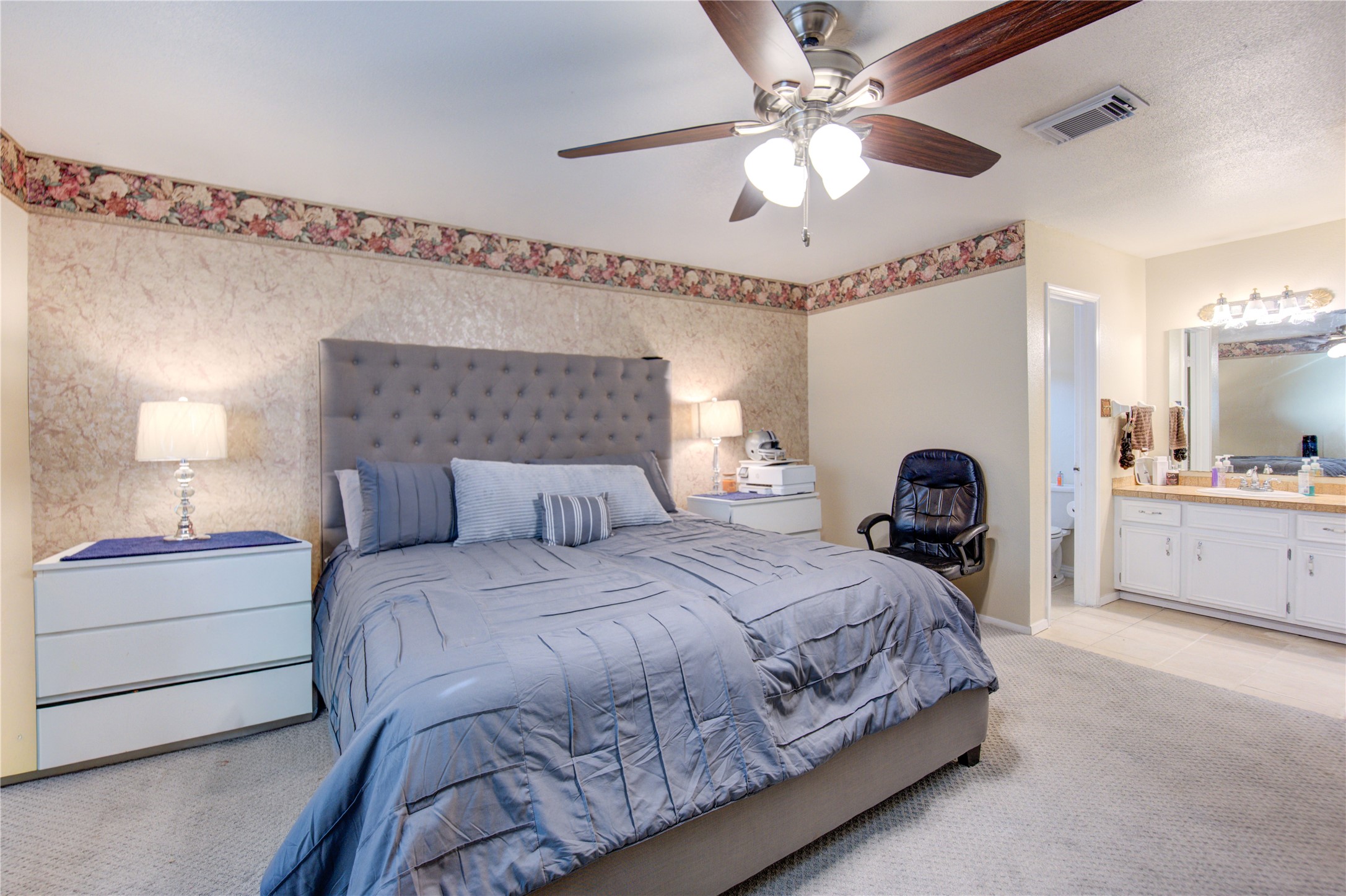 1403 Packsaddle Lane Baytown, TX 77521 - Photo 15 of 19 a bedroom with a bed and a chandelier