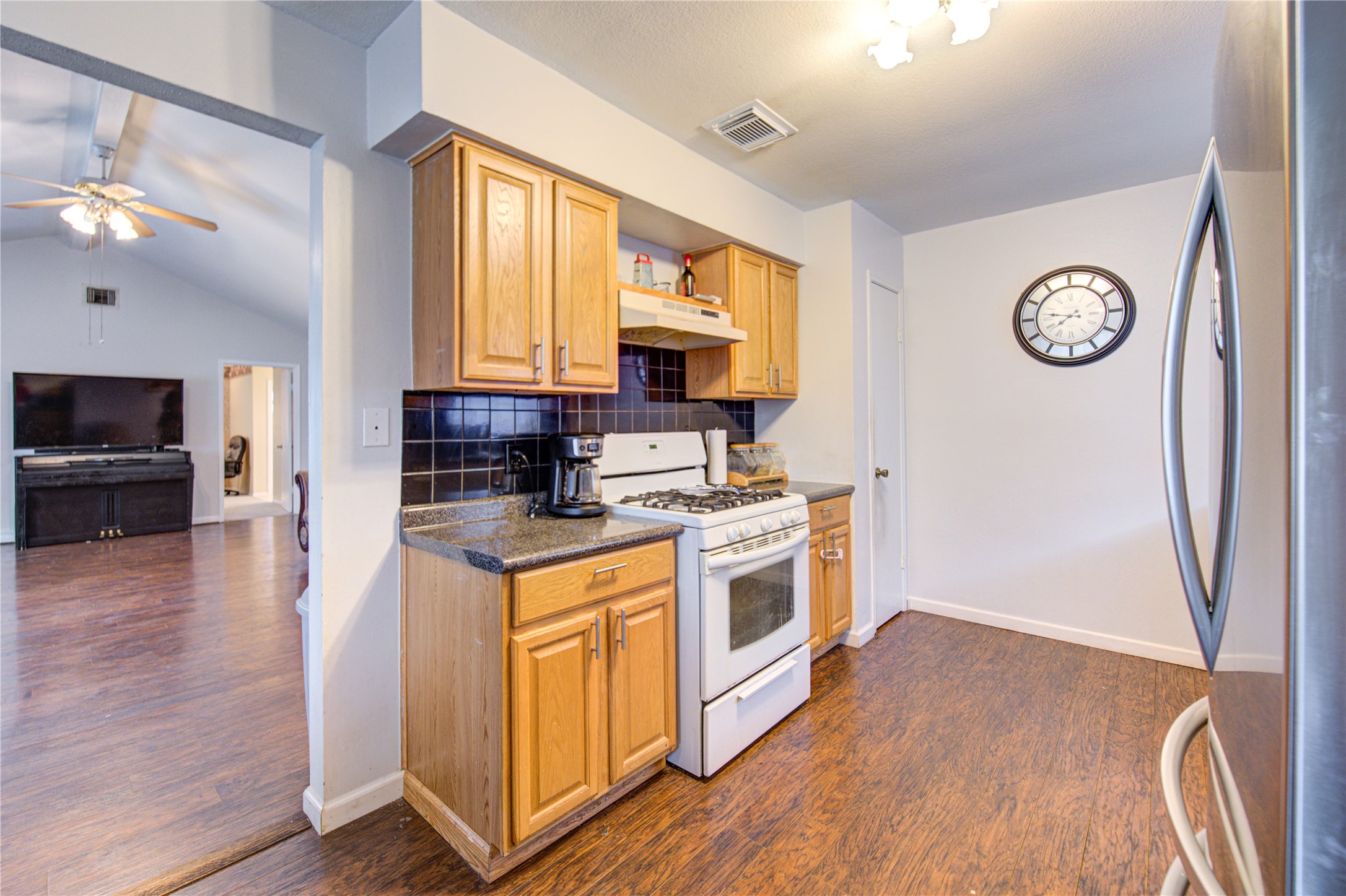 1403 Packsaddle Lane Baytown, TX 77521 - Photo 7 of 19 a kitchen with stainless steel appliances granite countertop a stove and a refrigerator
