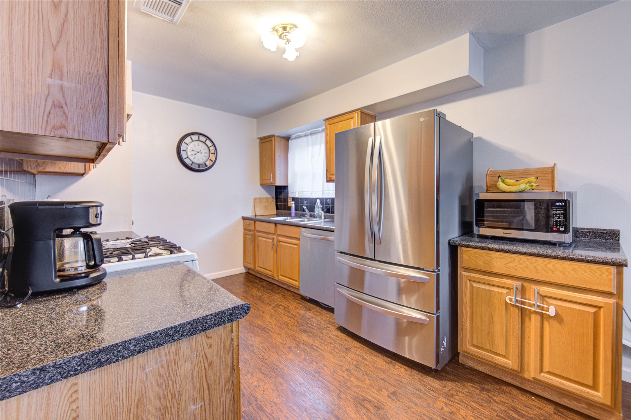 1403 Packsaddle Lane Baytown, TX 77521 - Photo 8 of 19 a kitchen with granite countertop stainless steel appliances a counter space and a window