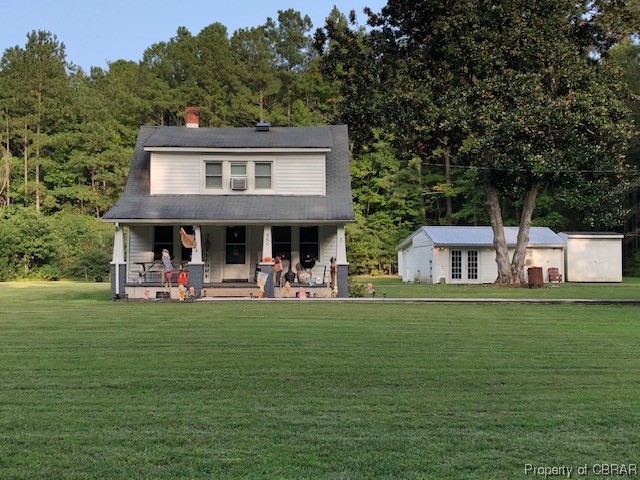 460 Holly Point Road Mathews, VA 23109 - Photo 1 of 16 a front view of a house with garden