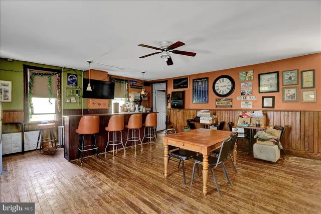 a view of a kitchen with cabinets and wooden floor