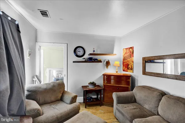 a view of empty room with window and wooden floor