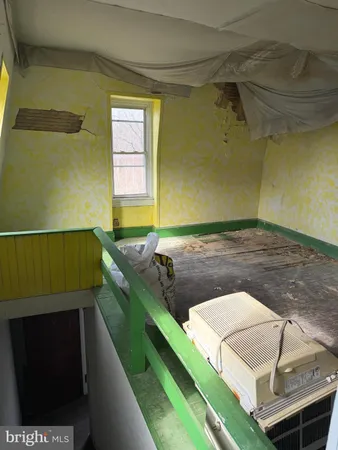 a view of a livingroom with an empty space and a window