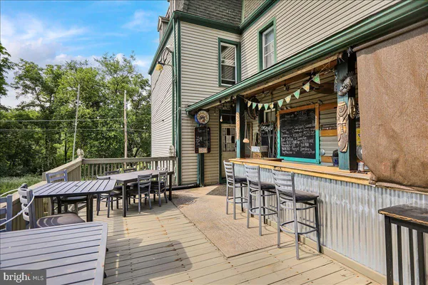 a roof deck with a table and chairs