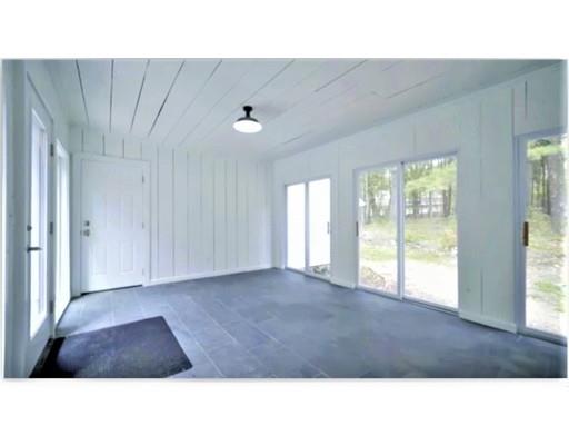 95 Old Mill Road Harvard, MA 01451 - Photo 34 of 42 a living room with a couch and a floor to ceiling window