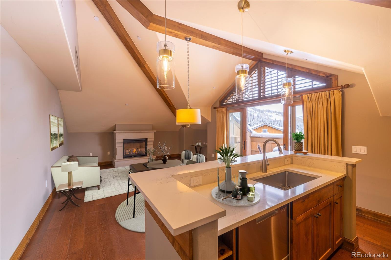 16 Vail Road, Unit 401 Vail, CO 81657 - Photo 17 of 35 a view of a kitchen with a sink and dishwasher a dining table with wooden floor