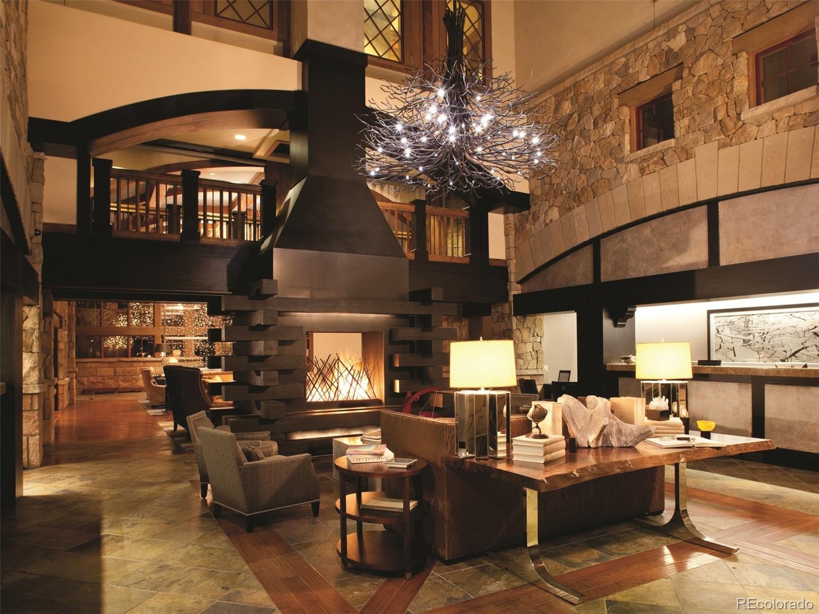 16 Vail Road, Unit 401 Vail, CO 81657 - Photo 7 of 35 a living room with patio furniture and a chandelier