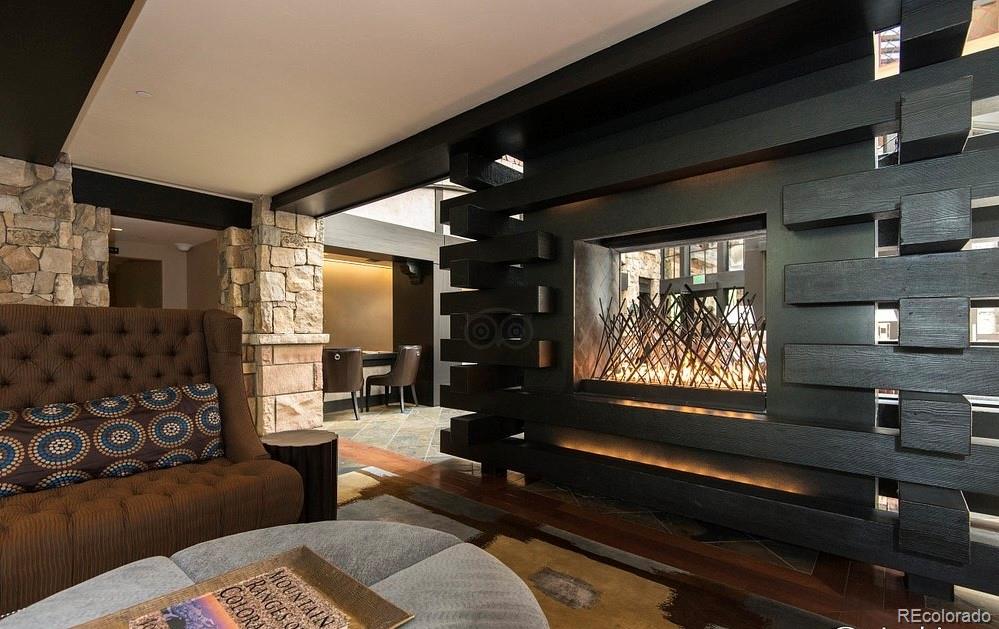 16 Vail Road, Unit 401 Vail, CO 81657 - Photo 8 of 35 a living room with furniture and a flat screen tv