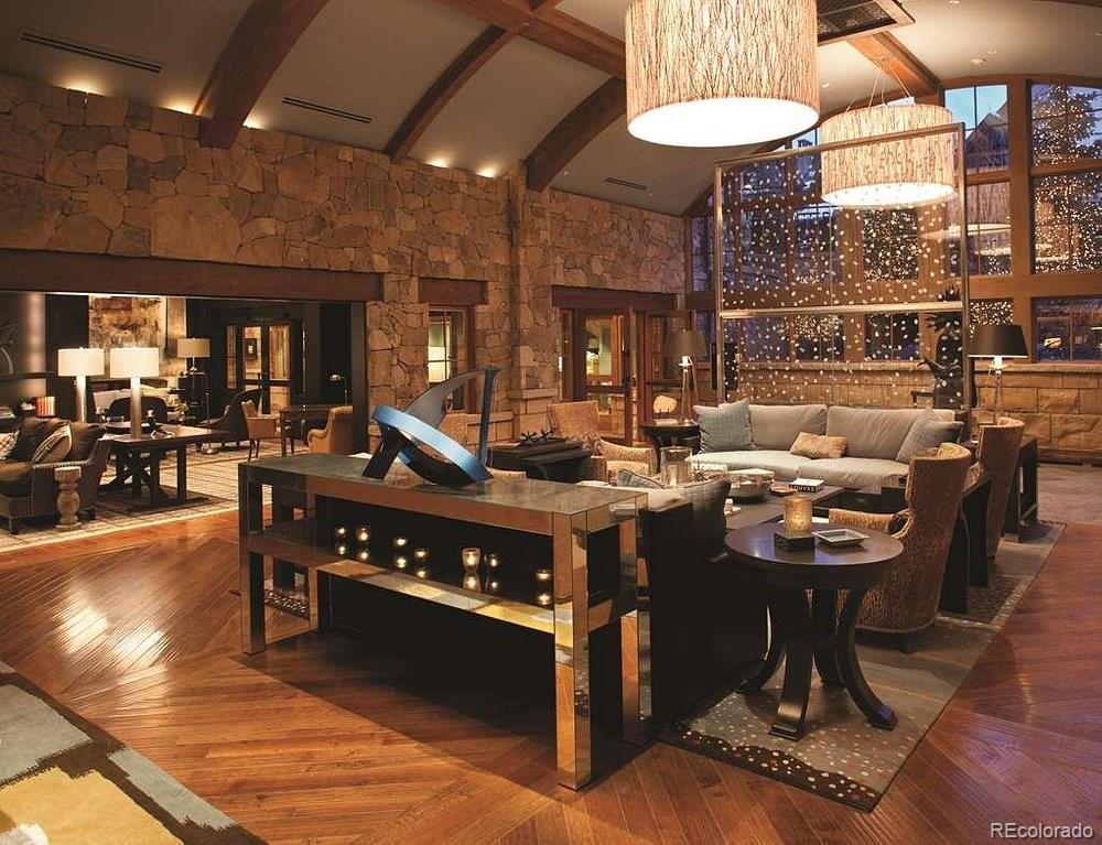 16 Vail Road, Unit 401 Vail, CO 81657 - Photo 9 of 35 a living room with furniture a rug and a fireplace