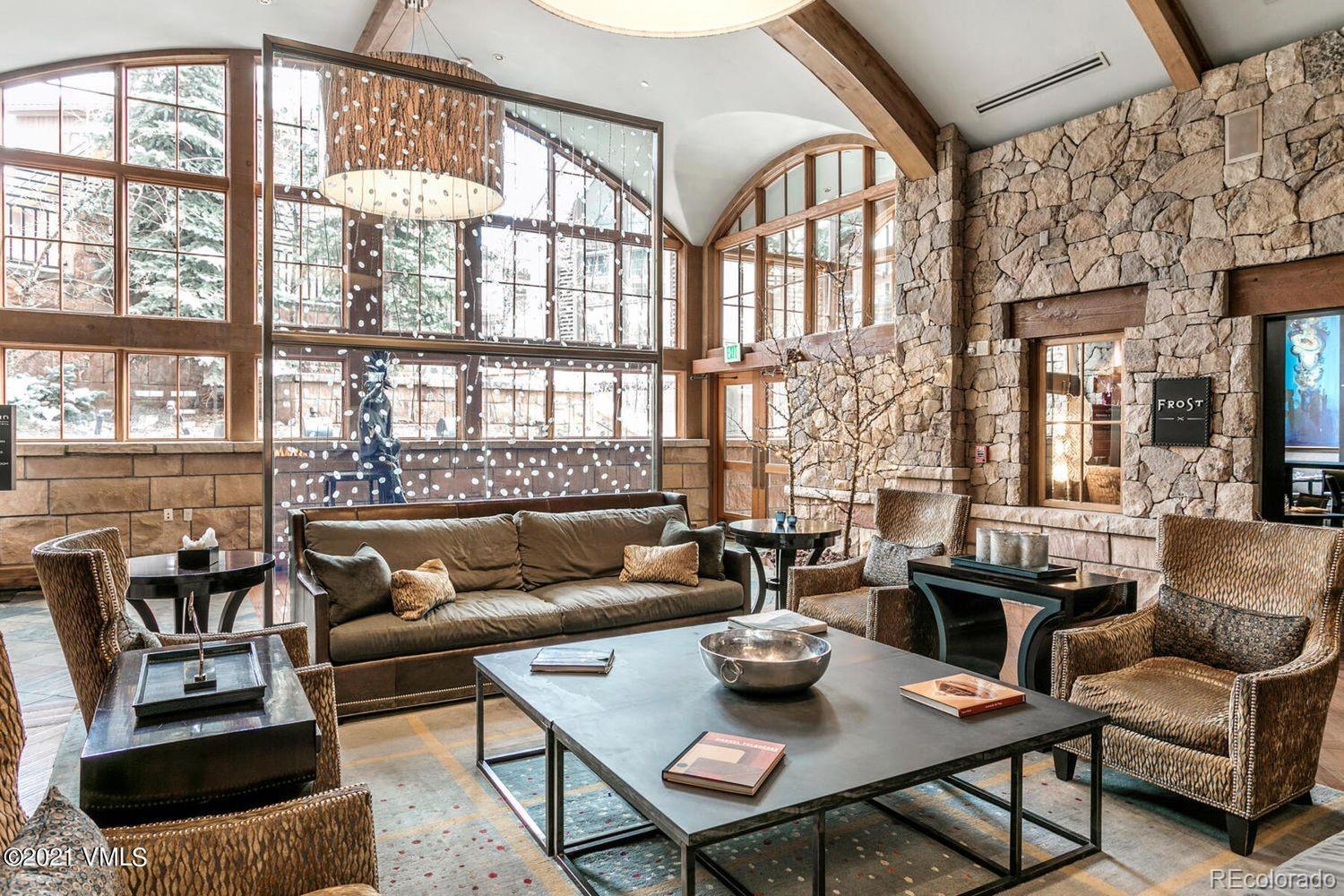 16 Vail Road, Unit 401 Vail, CO 81657 - Photo 10 of 35 a living room with furniture and a large window