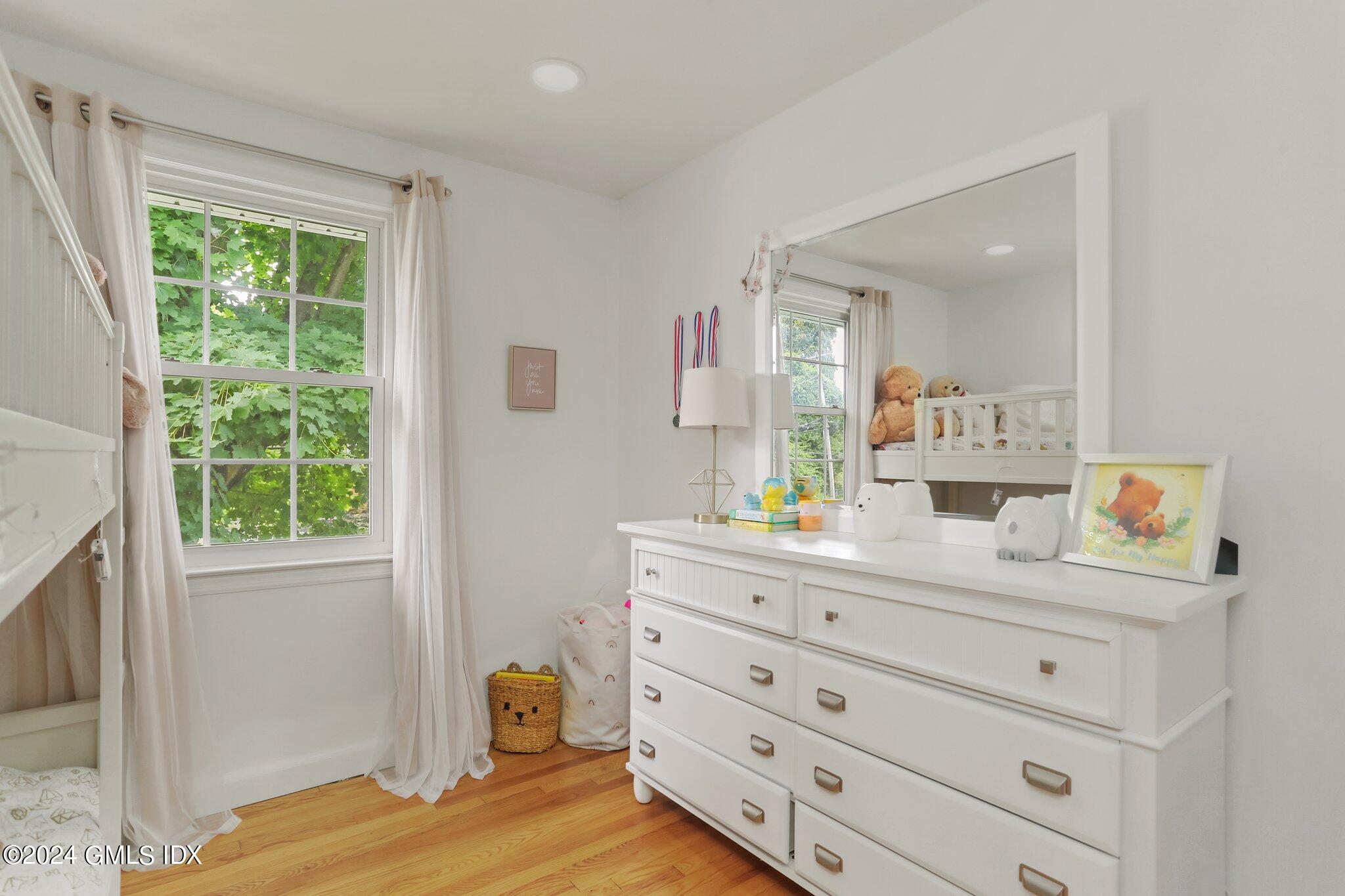 565 River Road Cos Cob, CT 06870 - Photo 16 of 29 a bedroom with a bed and a dresser