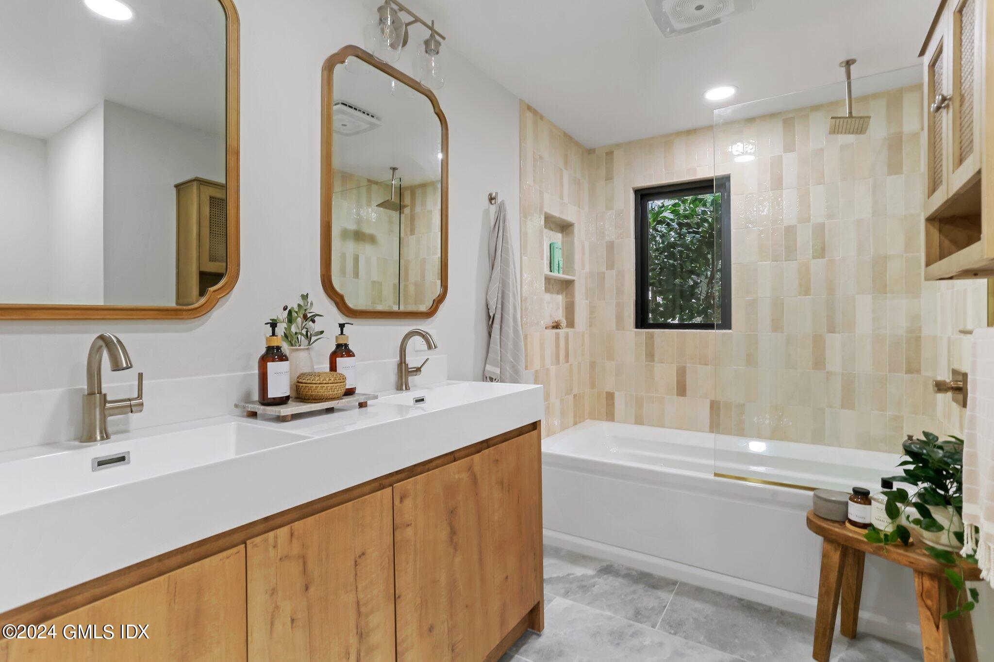 565 River Road Cos Cob, CT 06870 - Photo 17 of 29 a bathroom with a tub sink and mirror
