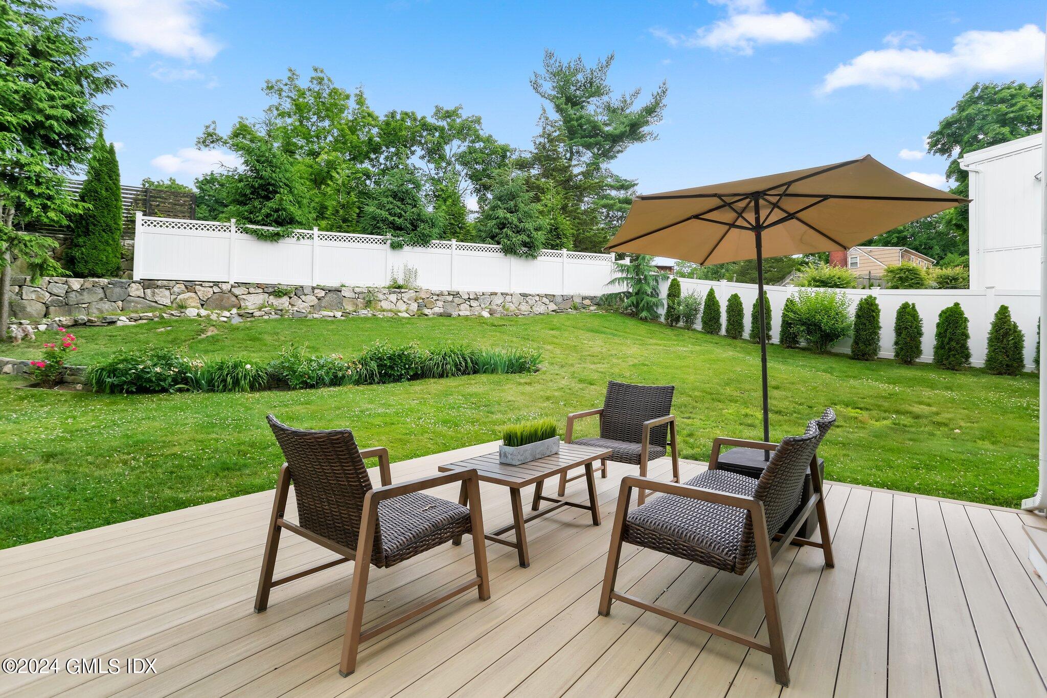 565 River Road Cos Cob, CT 06870 - Photo 21 of 29 a view of a chairs and table on the garden