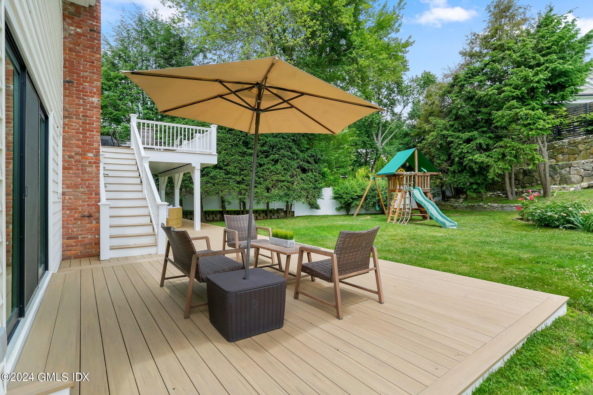 565 River Road Cos Cob, CT 06870 - Photo 22 of 29 a view of house with backyard outdoor seating and hardwood