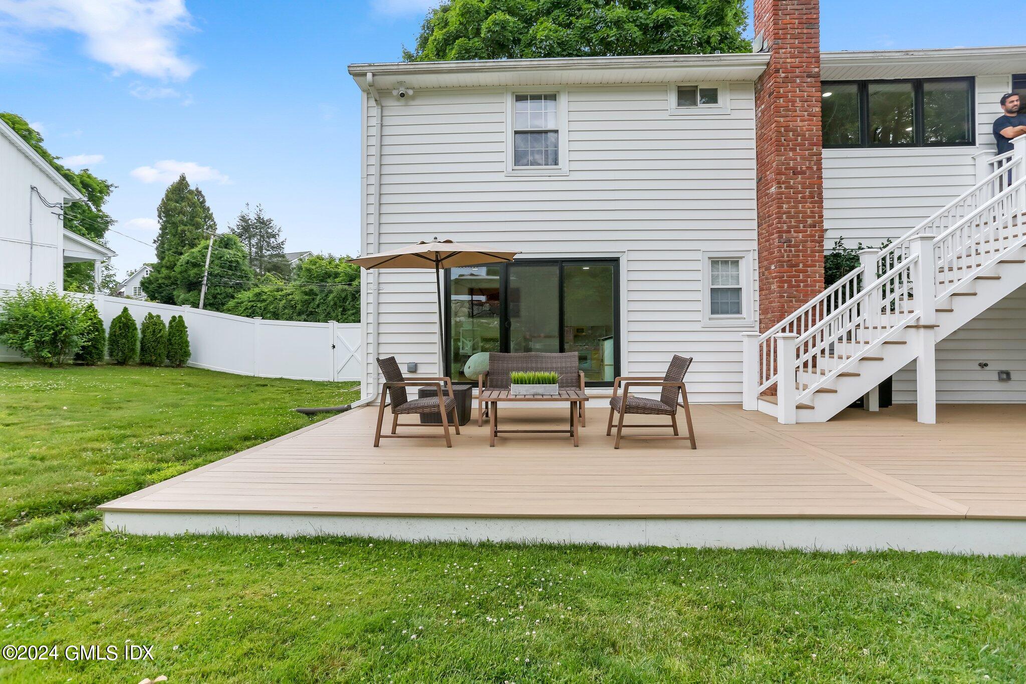 565 River Road Cos Cob, CT 06870 - Photo 23 of 29 a view of a house with patio and a yard
