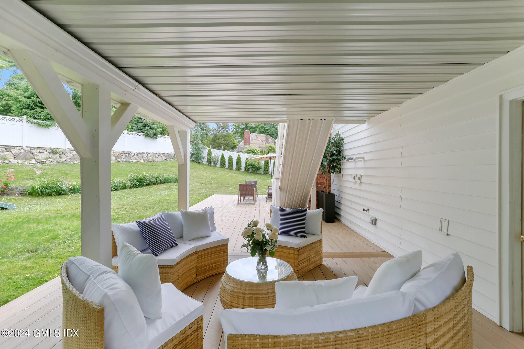 565 River Road Cos Cob, CT 06870 - Photo 24 of 29 a view of a patio with couches chairs dining table and chairs