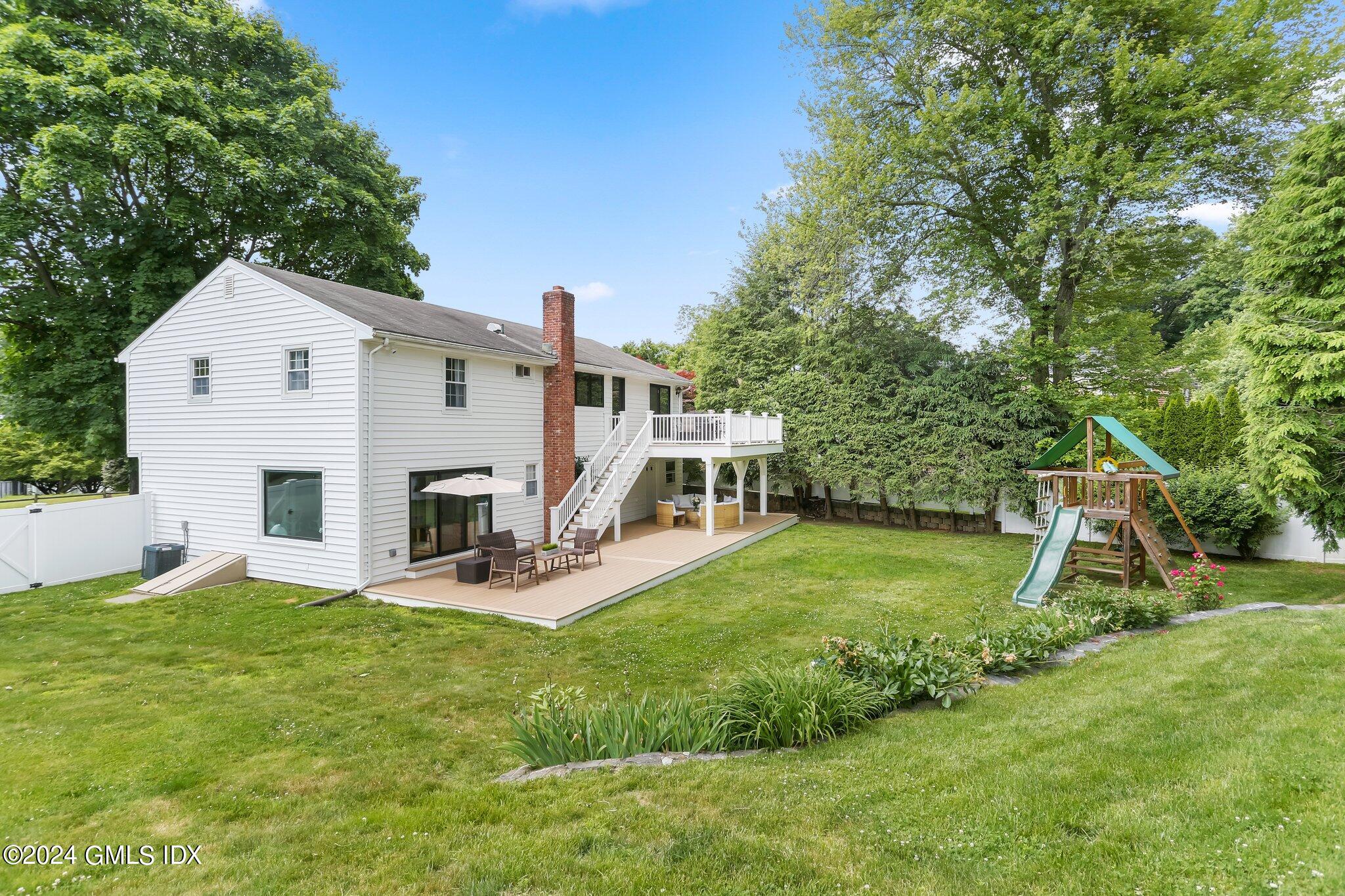 565 River Road Cos Cob, CT 06870 - Photo 25 of 29 a view of a house with a yard and sitting area