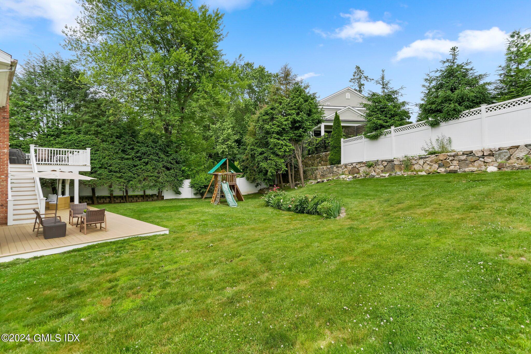 565 River Road Cos Cob, CT 06870 - Photo 26 of 29 a view of a backyard with a patio