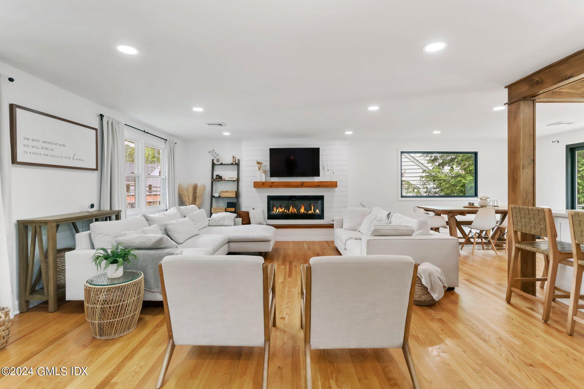 565 River Road Cos Cob, CT 06870 - Photo 3 of 29 a living room with fireplace furniture and a wooden floor