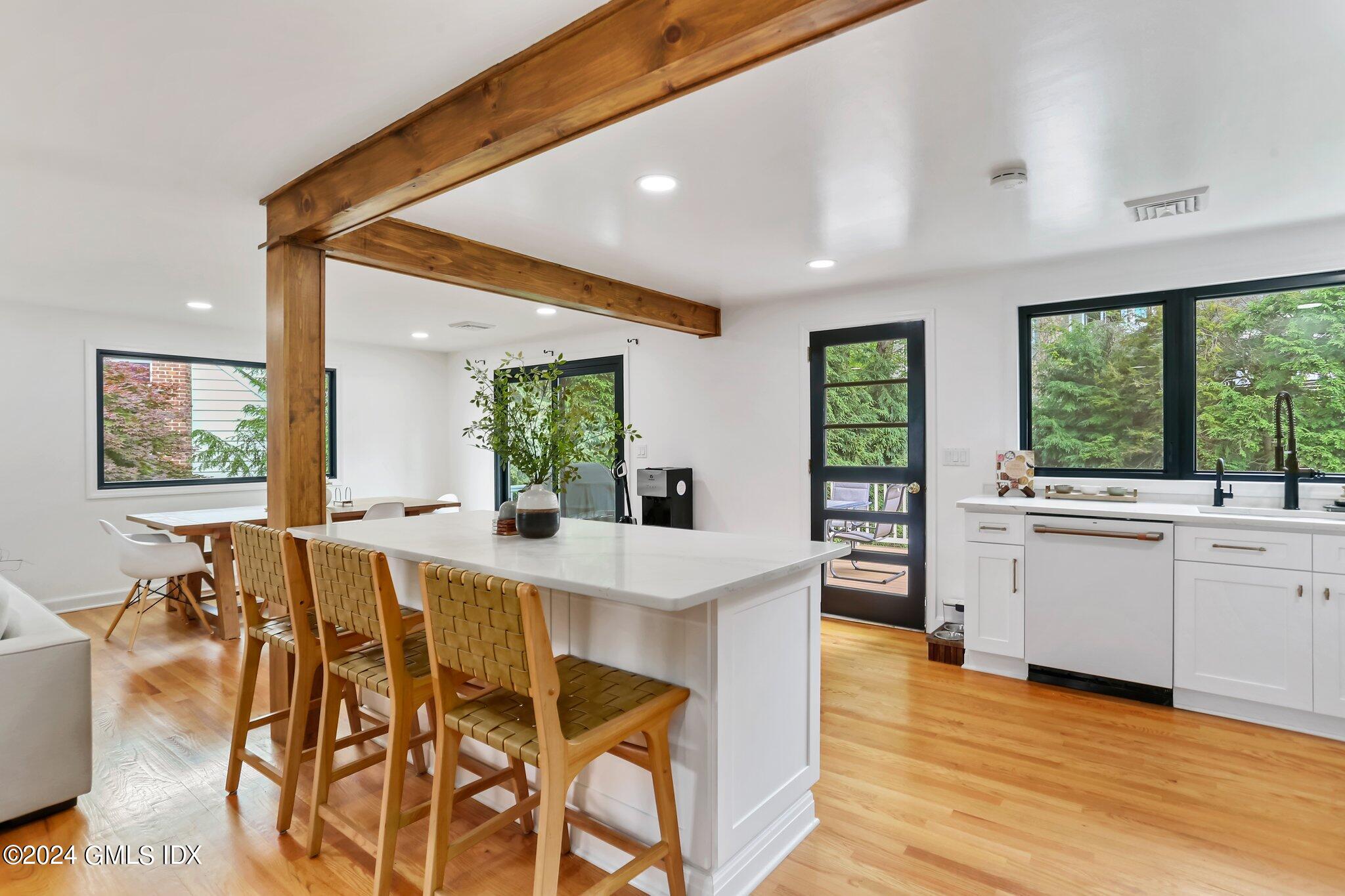 565 River Road Cos Cob, CT 06870 - Photo 8 of 29 a view of a dining room with furniture window and wooden floor