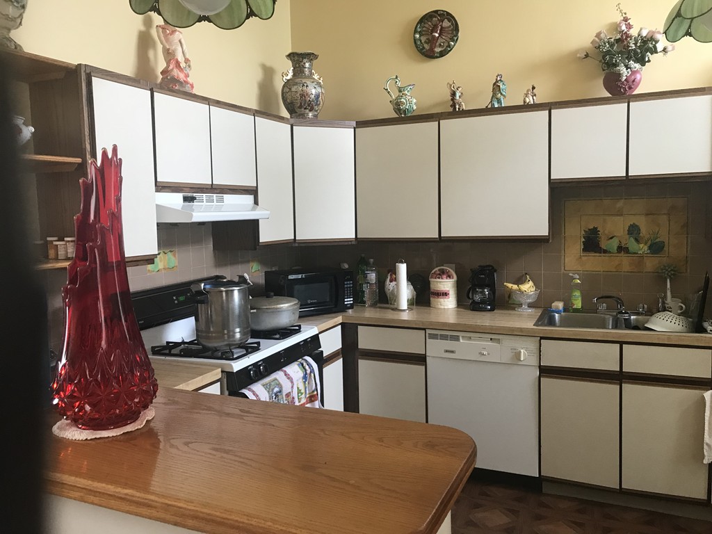 870 Pine Street Fall River, MA 02720 - Photo 16 of 19 a kitchen with stainless steel appliances granite countertop a sink a stove and white cabinets
