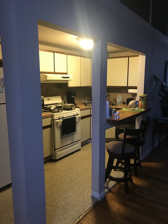 870 Pine Street Fall River, MA 02720 - Photo 4 of 19 a kitchen with a stove a sink and a microwave