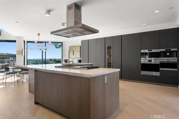 a kitchen with stainless steel appliances a refrigerator and a stove top oven