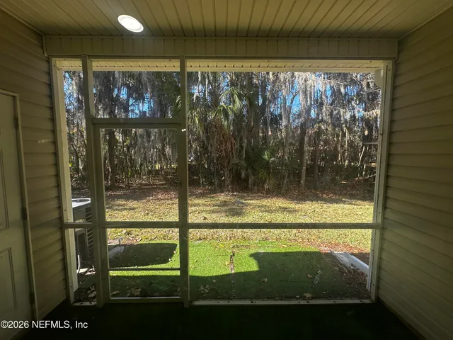 a view of a glass door with a tree