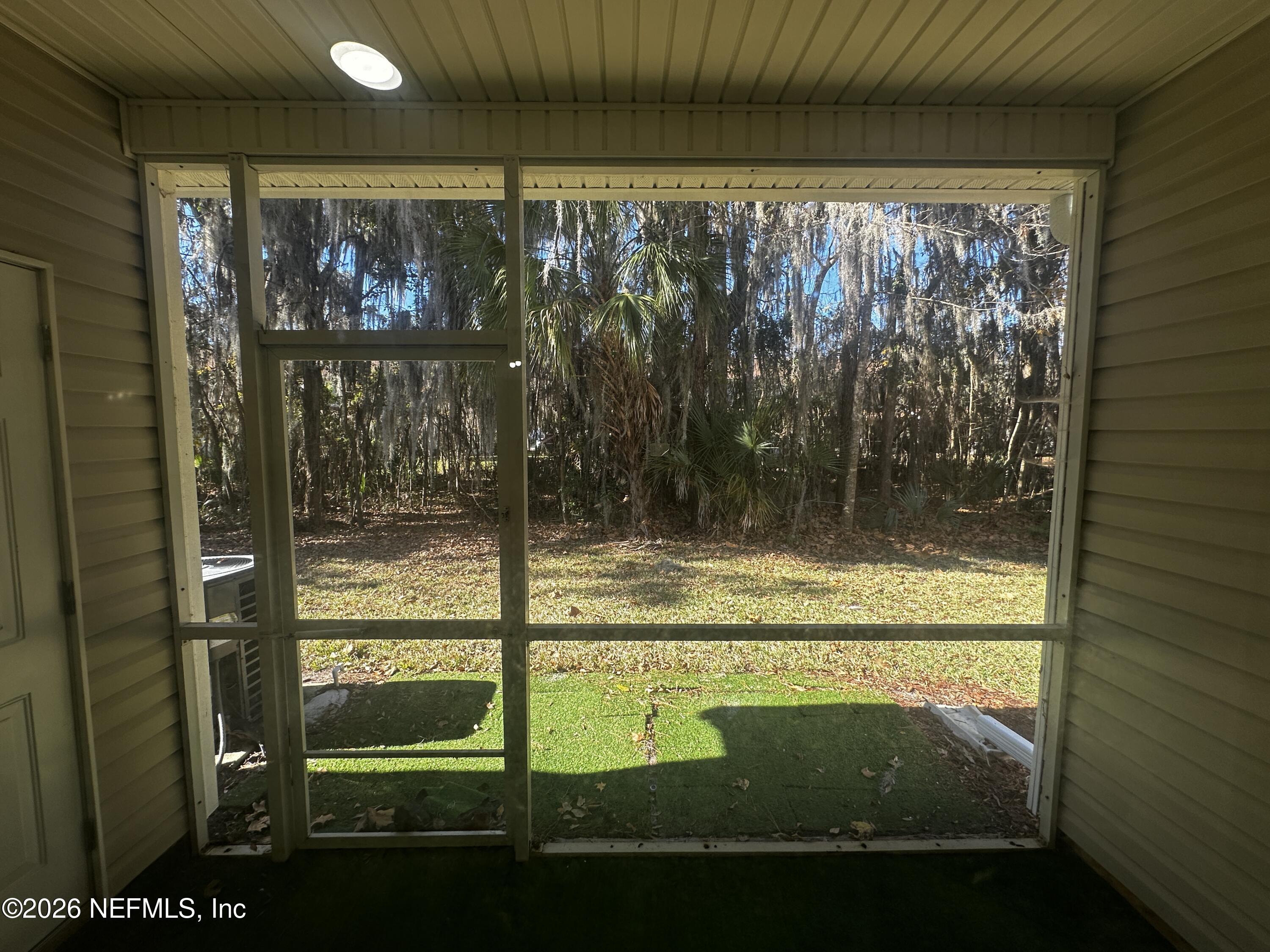 3548 Lone Tree Lane Jacksonville, FL 32216 - Photo 3 of 10 a view of a glass door with a tree